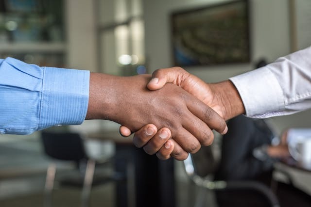 two people shaking hands 