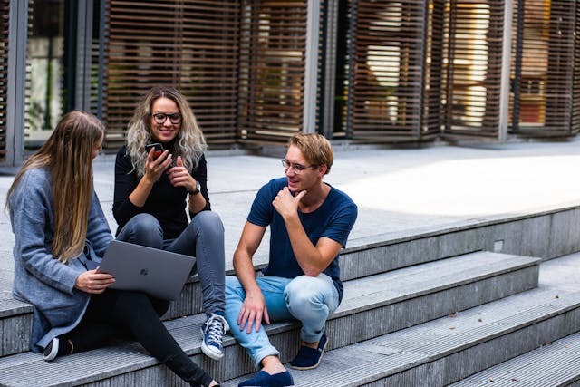 students sitting on a staircase