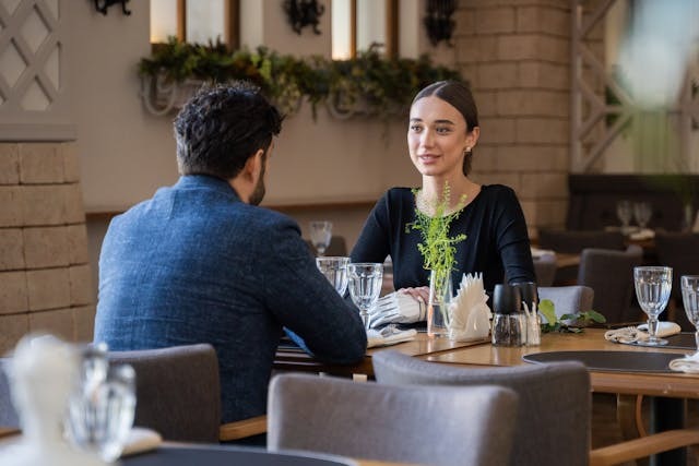 two people sitting at a dinner table