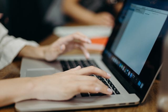 person typing on a laptop 