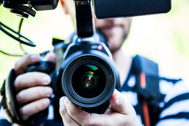 Person holding a proffessional camera up