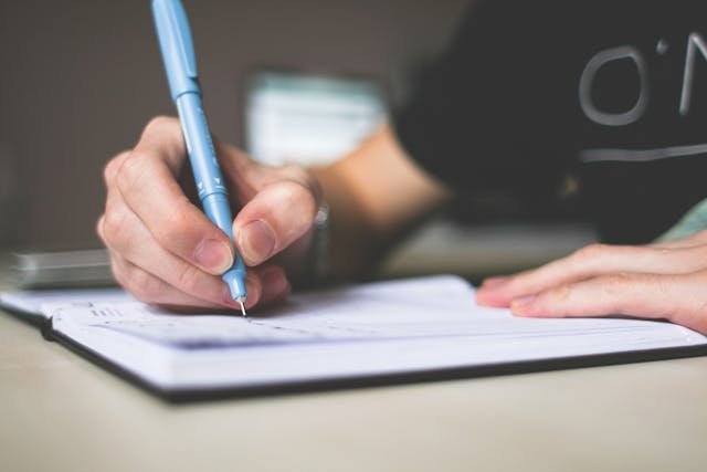 person writing in a notebook